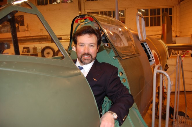 Artist Steve Harper the Honorary Patron of Shuttleworth in the beautifully restored  cockpit of the Mk 5 c Spitfire  at Shuttleworth