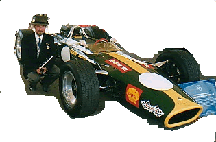 Steve Harper British Artist and Illustrator, pictured standing beside Graham Hill's 1967 Lotus Cosworth 49